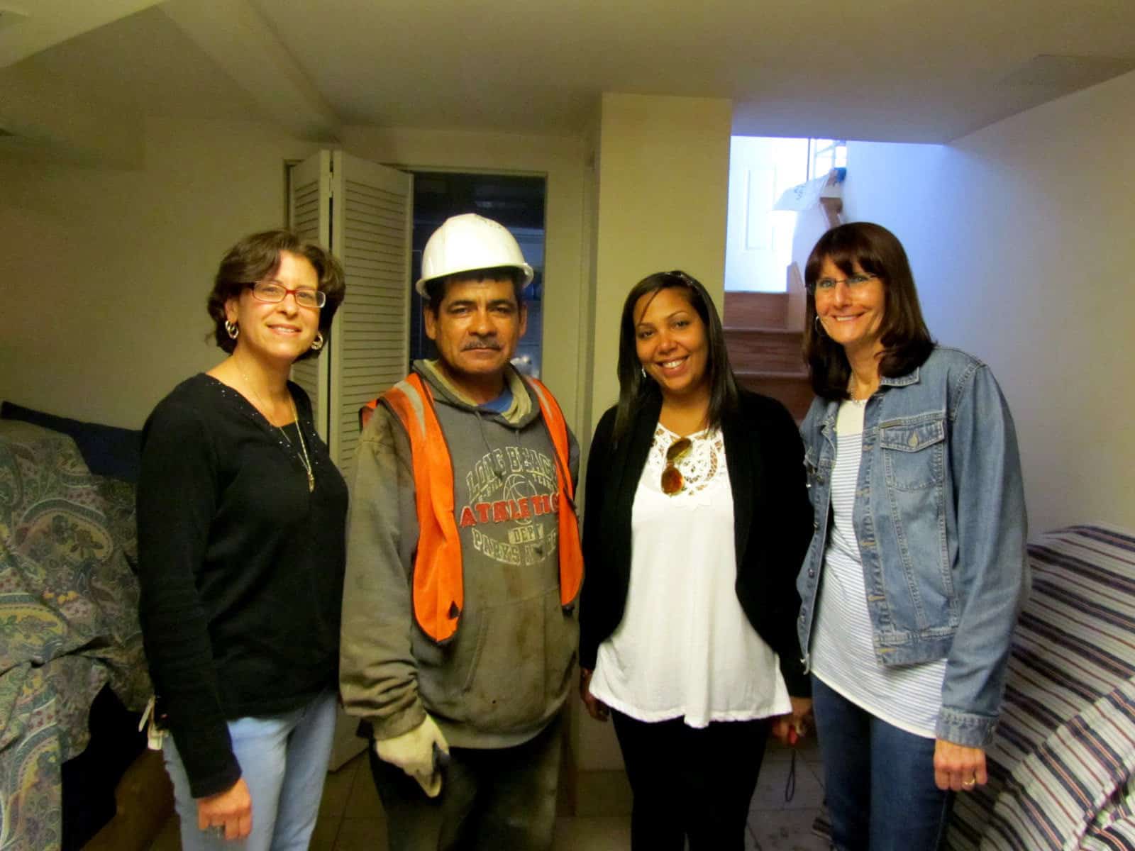 Co-workers on a company field trip, inside a customer's basement.