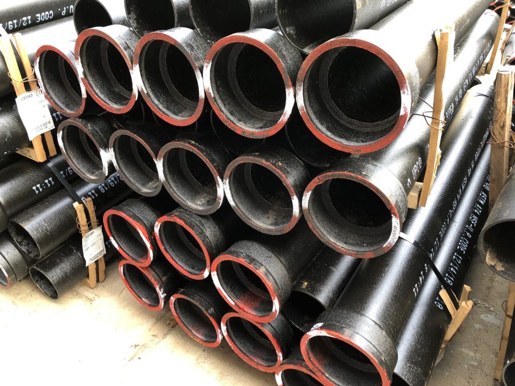 cast iron ground pipes stacked in stock