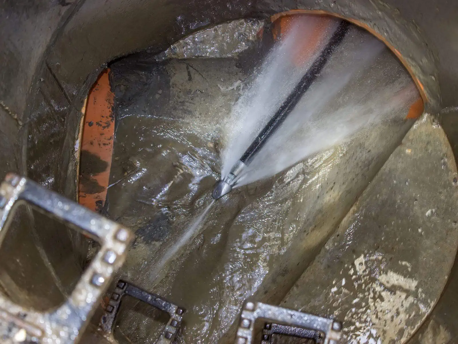A high pressure water jet cleaning out a main public sewer line.