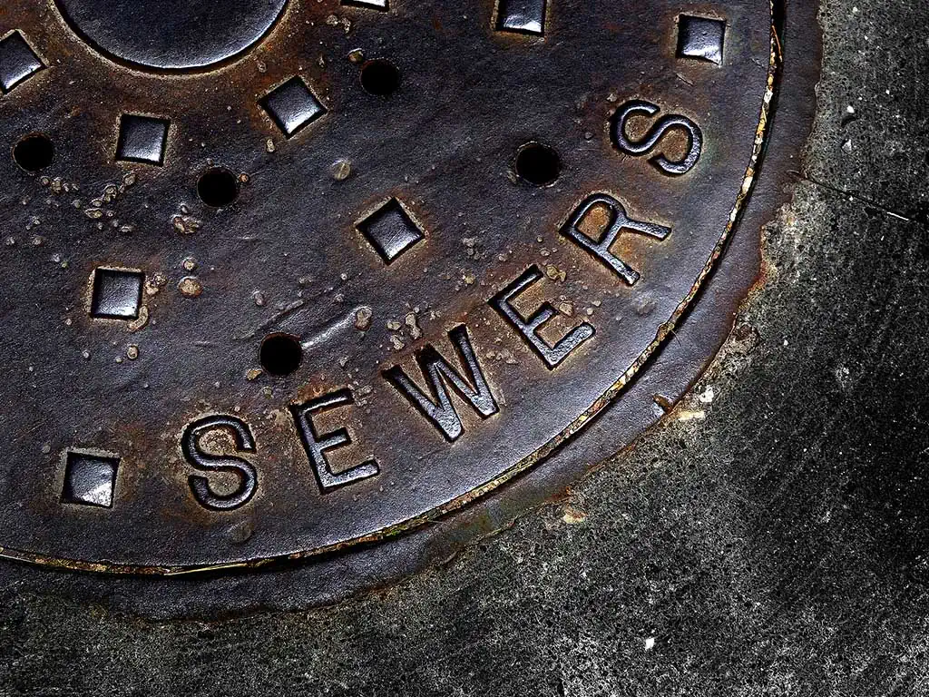 Sewer main drain manhole cover.
