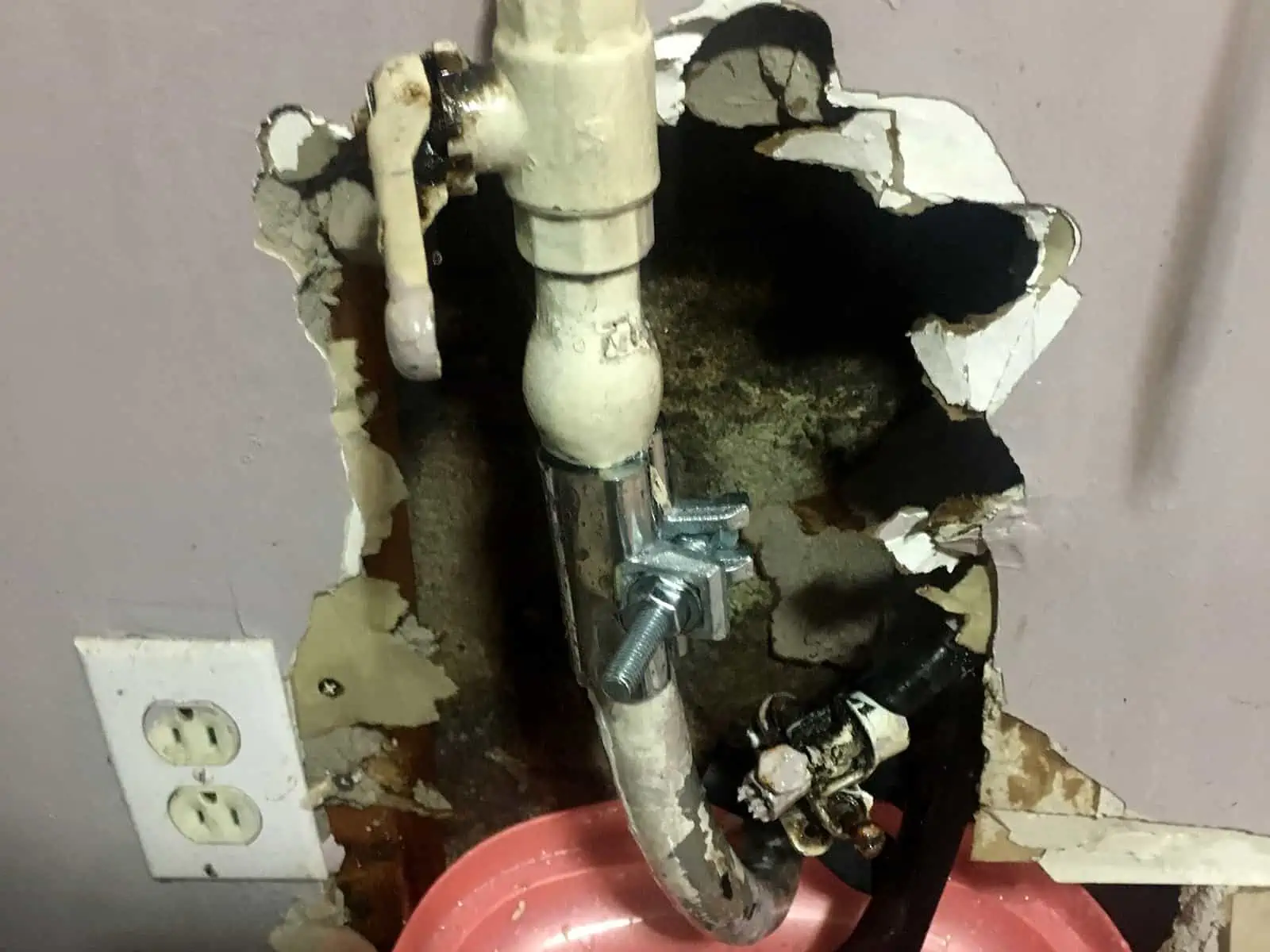 An all-around pipe leak repair clamp on a lead water service line.