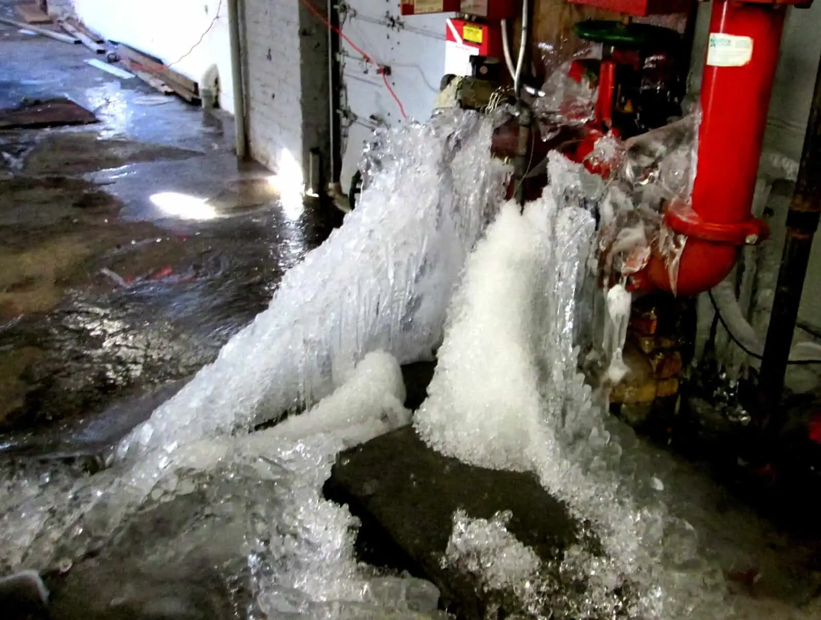 A plumbing emergency caused by a frozen water main splitting apart.